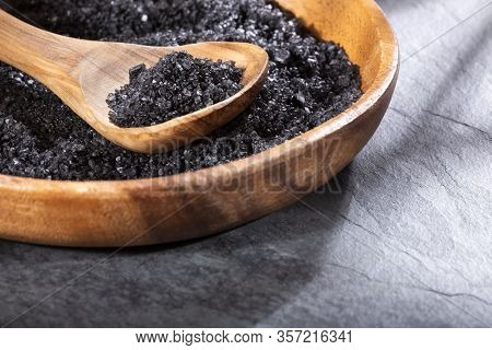 Hawaiian Black Salt In Wooden Bowl. Text Space