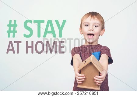 Stay Home Concept. Coronavirus Prevention. Boy Holds Small House. Staing Home In Quarantine. Stay At