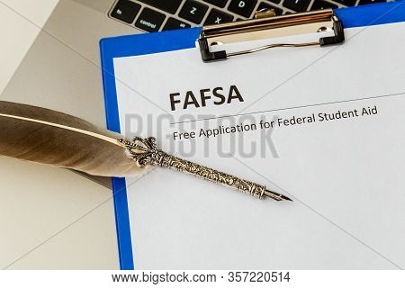 Fafsa. Student Aid Statement Form And Money On The Tablet.