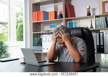 Asian Man Wearing Masks And Working From Home During Covid-19 Quarantine And Business Has A Problem,