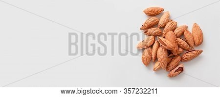 Bunch Of Inshell Almonds With Copy Space On Gray Background. Proper Nutrition Balance