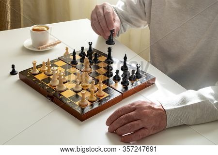 A Middle-aged Man Or A Pensioner Plays Chess In Quarantine Or In His Spare Time. Quarantine, Covid-1