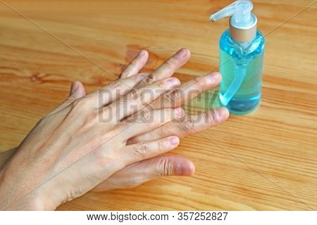 Cleaning Hands With Sanitizer By Right Palm Rubbing Over Left Dorsum With Fingers Interlaced For Han