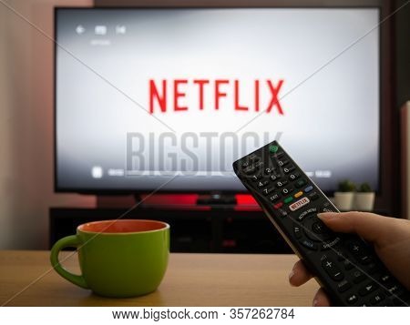 Uk, March 2020: Tv Television White Netflix Background With Remote Control