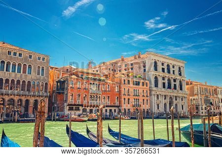 Grand Canal Waterway In Venice With Docked, Moored And Sailing Gondolas Boats, Palazzo Cavalli Palac