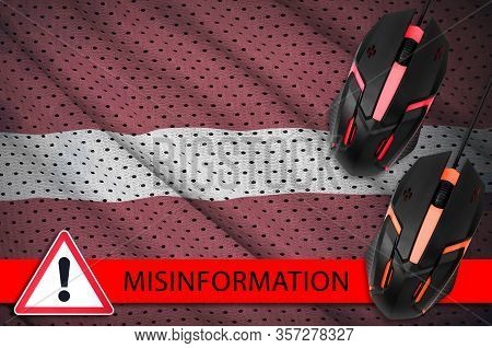 Latvia Flag And Two Computer Mouses. Misinformation During Coronavirus Or 2019-ncov Virus Concept