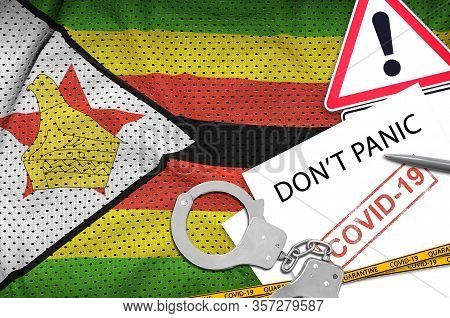 Zimbabwe Flag And Police Handcuffs With Inscription Dont Panic On White Paper. Coronavirus Or 2019-n