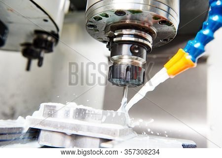 CNC milling machine work. Coolant and lubrication in metalwork industry