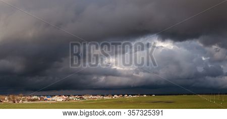 Storm Clouds Thunderclouds Over The Village In Spring