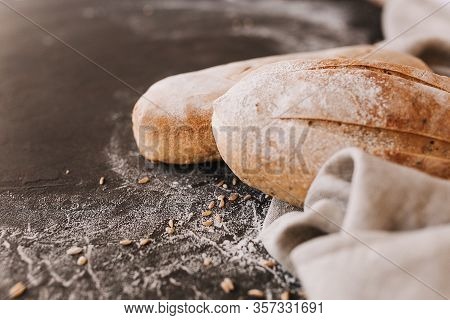 Various Crispy Bread And Buns On The Stone Table, Loaf Of Fresh Baked Artisan Sliced Rye Bread Over 