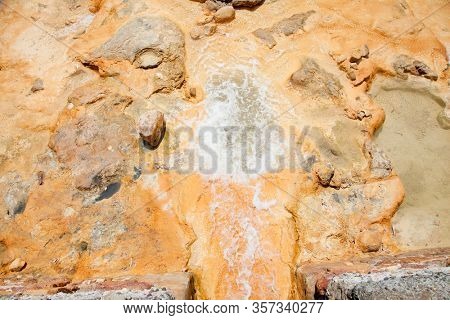 Warm medicinal spa water that springs from the rocks on the Aegean coast. Lutra Edipsou, Evia island, Greece