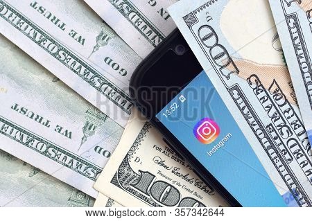 Smartphone Screen With Instagram App And Lot Of Hundred Dollar Bills. Business And Social Networking