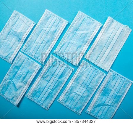Medical Protective Masks On Blue Background.  Healthcare And Medical Concept. Covid-19 - Wuhan Novel
