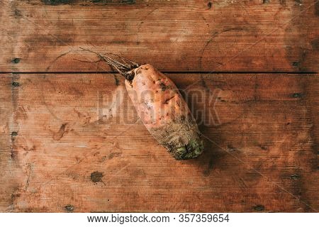 Ugly Misshapen Carrots On Wooden Background. Concept Of Zero Waste Production. Top View. Copy Space.