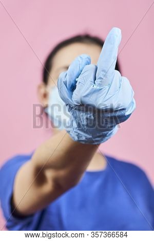 Woman Showing Middle Finger Handgesture. Get Out Covid-19 Or Stop Coronavirus Concepts. Time To Stay