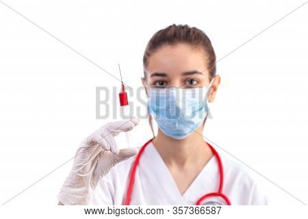 Female Nurse With A Syringe Over A White Background