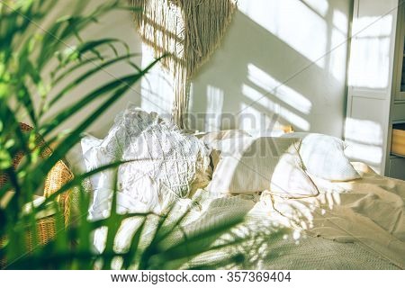 Cozy Boho Style Sunny Bedroom With Close Up Of Green Fresh Tropical Houseplant Palm Leaves. Urban Ju