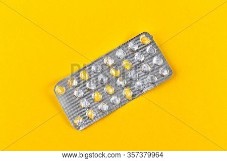Used Blister Pack From Tablets Medicine On Yellow Background. Medical Blister Pack Opened And Empty 