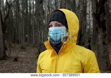 Portrait Of Young Woman With Medical Mask On Her Face During Coronavirus Pamdemic