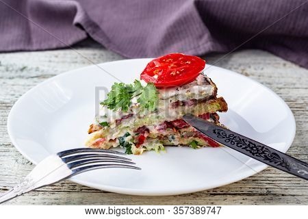Pice Of Zucchini Cake With Tomatoes And Fresh Parsley On White Wooden Background.