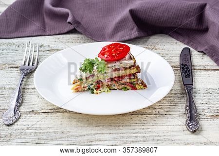 Pice Of Zucchini Cake With Tomatoes And Fresh Parsley On White Wooden Background.
