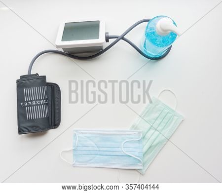 Top View Of Alcohol Gel, Mask, Digital Blood Pressure Monitor. Corona Anti-virus Device.protec The S