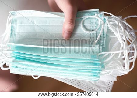 Womans Hand Holding Medical Face Masks. Coronavirus Or Covid -19 Prevention. Clobal Pandemic. Virus 