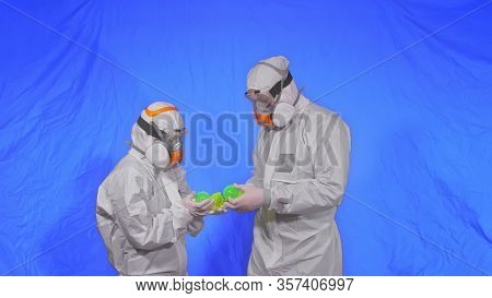 Doctor In Respirator Show A Virus Model. Slow Motion. Woman Wearing Protect Medical Aerosol Spray Pa