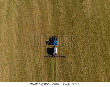 Tractor Applying Liquid Mineral Fertilizers To The Soil On Winter Wheat