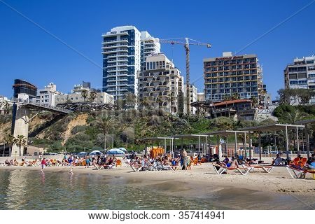 Israel, Netanya, March, 2016 - New Modern Waterfront Architecture On A Green Hill And People Enjoyin