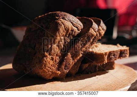 Sliced ​​black Rye Bread On A Wooden Board. Brick-shaped Bread.