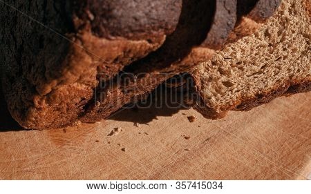Sliced ​​black Rye Bread On A Wooden Board. Brick-shaped Bread.