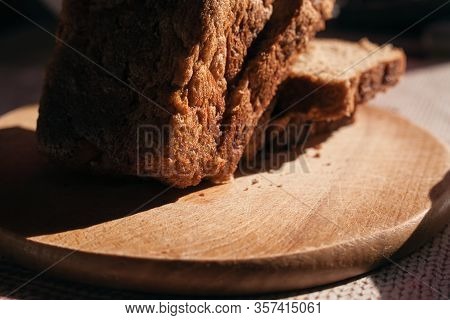 Sliced ​​black Rye Bread On A Wooden Board. Brick-shaped Bread.