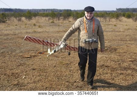 Elderly Man Holds Rc Airplane With A Broken Propeller After The Crash.