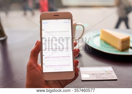 Closely Woman Holding Mobile Phone With Blurred Payment Notifications On The Screen, Near On The Res