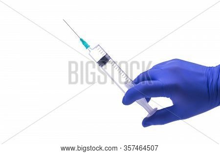 Hand In A Blue Medical Glove Holds A Syringe Vertically, White Background, Isolated Object