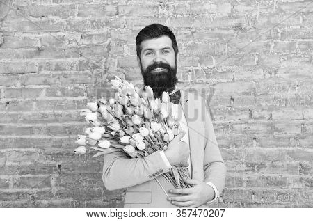 Spring Style. Womens Day Is On March 8. Spring Gift. Bearded Man Hipster With Flowers. Love Date. In