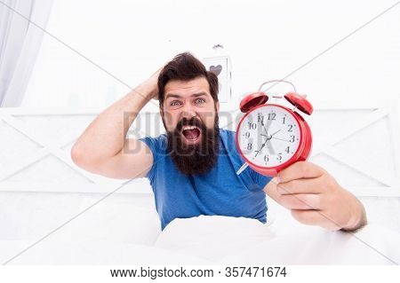 Get Up Right Now. What Time Is It. Stressed Man Alarm Clock. Sleepy Man Holding Alarm Clock In Bed. 
