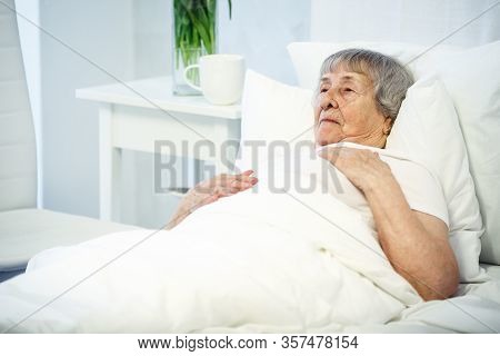 Healthcare In Hospital Concept. Old Lady Lyiing In Bed