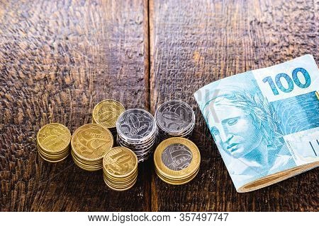 Close Up Of Brazil Coins And 100 Reais Bank Notes, Background Image With Concept Of Finance, Economy