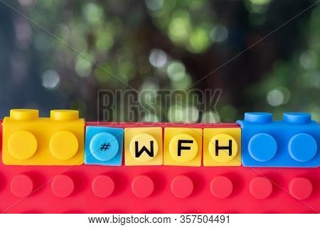A Block Word - #wfh (work From Home). Business Concept Background