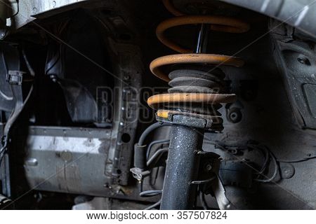 Close-up Car Arch With Cushioning Strut, Metal Spring, Wheel In An Old Car