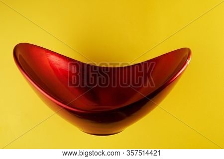 red oval shape oriental container on yeollow background