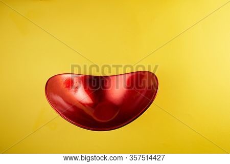 red oval shape oriental container on yeollow background