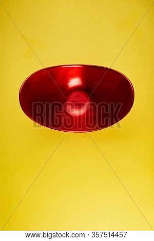 red oval shape oriental container on yeollow background