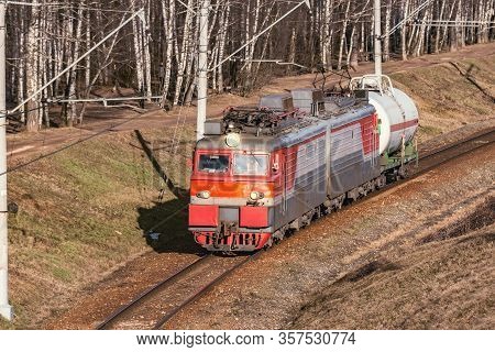 Freight Train Moves By The Forest At Spring Day Time.