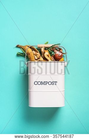 Garbage Sorting. Organic Food Waste From Vegetable Ready For Recycling In Compost Bin On Blue Backgr