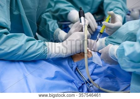 Team Of Professional Doctors Performing Operation In Surgery Room