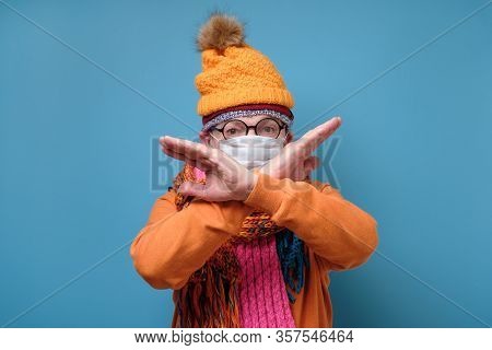 Man With Medical Mask As Protection From Covid-19 Showing Stop Geture