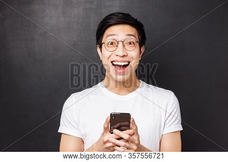 Technology, Messaging And People Concept. Close-up Portrait Of Excited And Amused Happy Asian Man, S
